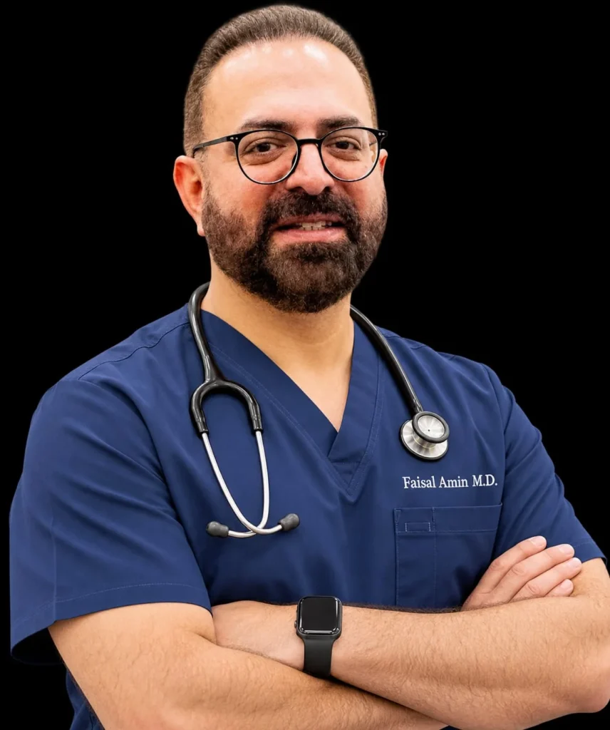 Dr Faisal Amin, MD, founder of Crescent Wound Care, in navy scrubs with a stethoscope